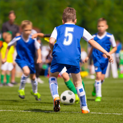 Boys playing soccer on the field