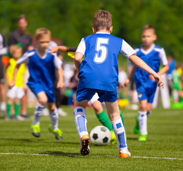 Boys playing soccer on the field