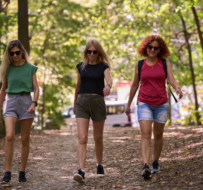 women hiking outdoors in a heavy tick populated area